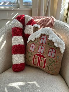 a gingerbread house pillow sitting on top of a chair