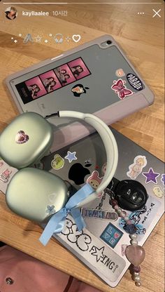 the computer mouse is next to some stickers and other items on a wooden table