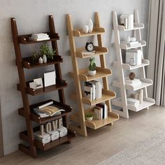 three bookshelves are lined up against the wall, one is leaning to the side