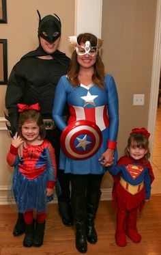 a family dressed up as superheros and their children are posing for a photo together