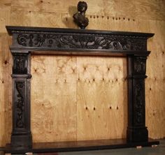 an old fireplace with wood paneling and carvings on the mantles is being worked on