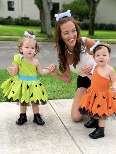 a woman and two children dressed up in costumes