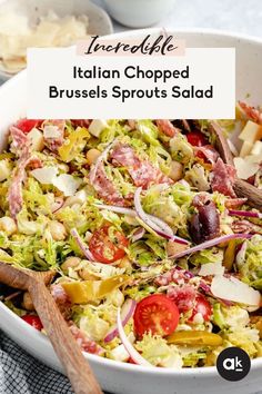 a salad in a white bowl with wooden serving utensils on the side and text overlay that reads, incredible italian chopped brussels sprouts salad