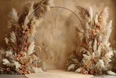 two tall floral arrangements with feathers and flowers on the top are arranged in front of a beige background