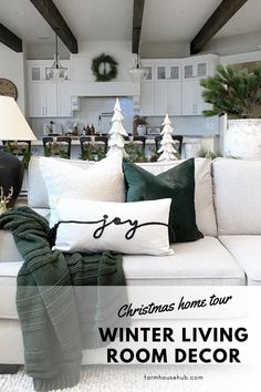 a living room filled with white furniture and christmas decorations