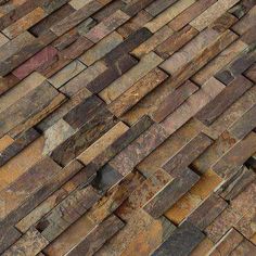 a close up view of a brick wall made from different types of bricks and stones