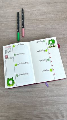 an open notebook with two markers on it