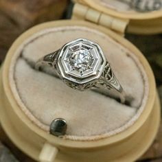 an antique diamond ring sits in a box