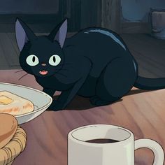 a black cat sitting on top of a wooden table next to a plate of food