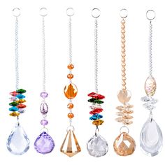 a row of different colored necklaces hanging from chains on a white background in various shapes and sizes