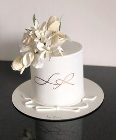 there is a white cake with flowers on it