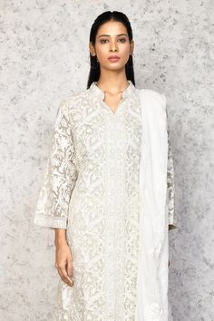 Cream kurta with thread embroidery in floral and paisley pattern. Paired with white flared pant and dupatta.
Components: 3
Pattern: Embroidery
Type Of Work: Thread, floral
Neckline: Mandarin collar
Sleeve Type: Long sleeves
Fabric: Georgette
Color: Cream
Other Details: 
Elasticated waistband
Lace border embellished dupatta
Occasion: Mehendi and Haldi - Aza Fashions White Flare Pants, Kurta Set For Women, White Kurta, White Flares, Nehru Jacket, Saree Blouses, Women Kurta, Pattern Embroidery, Straight Kurta