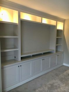 a living room with built in bookshelves and lights