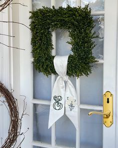 a wreath is hanging on the front door