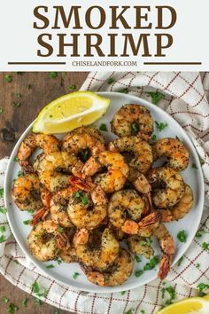 grilled shrimp on a plate with lemon wedges and parsley