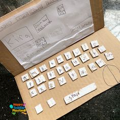 a cardboard box that has some type of keyboard on it with letters cut out from them