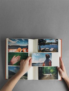 a person holding an open book with pictures on the pages and hands reaching for it