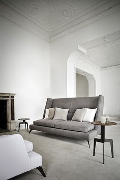 a living room filled with furniture and white walls