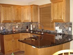 a kitchen with wooden cabinets and granite counter tops