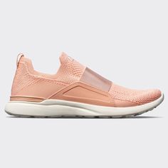 a women's pink sneaker with white soles and mesh detailing on the side