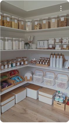 an organized pantry filled with lots of food and storage bins on the shelves above