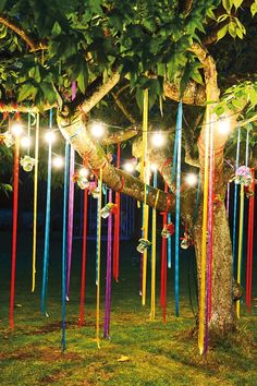 a tree that has been decorated with lights and streamers in the shape of ribbons