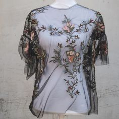 This Sheer, Floral Blouse Is An Elegant Piece To Paired With Jeans And A Wedge Heel. It's Perfect For A Fun Night Out With Your Girlfriends Or A Date Night. Spring Evening Mesh Top With Sheer Sleeves, Sheer Short Sleeve Tops For Evening, Feminine Spring Lace Top For Party, Feminine Lace Top For Spring Party, Feminine Summer Lace Top With Sheer Sleeves, Summer Party Blouse With Short Sleeves, Spring Party Mesh Top With Short Sleeves, Short Sleeve Lace Top Blouse For Fall, Chic Fitted Blouse With Floral Embroidery