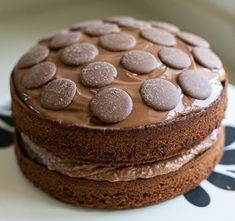 two cakes with chocolate frosting and oreo cookies on top are sitting on a plate