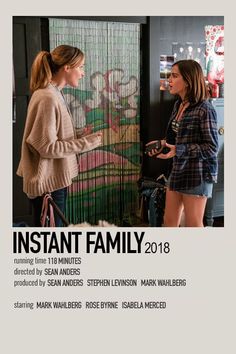 two women standing next to each other in front of a door with the words instant family on it