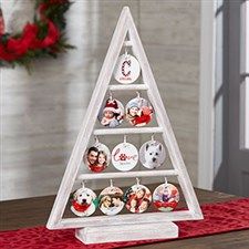 a wooden christmas tree with ornaments on it