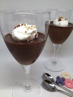 two glasses filled with chocolate pudding and whipped cream