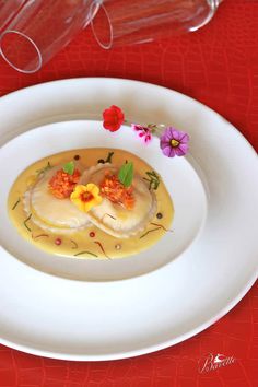 a white plate topped with food on top of a red table