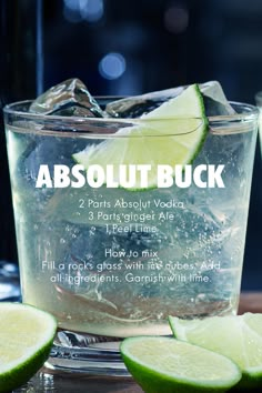 a glass filled with ice and limes on top of a table