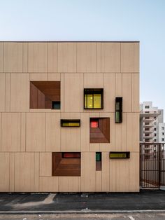 a building that has some windows on the side of it and is made out of wood