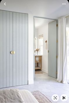 an open door leading to a bedroom with white walls