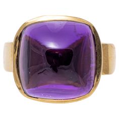 14k yellow gold ring. This lovely ring has a square sugarloaf cabochon cut dark purple color amethyst center, bezel set atop a modern profile, and wide, high polished yellow gold band. Marks: 14k Dimensions: 9/16" across the top x 1/2" wide Weight: 6.0 gross dwt Ring Size: 7 Luxury Classic Cabochon Amethyst Ring, Luxury Cabochon Amethyst Ring, Luxury Amethyst Cabochon Ring Collectible, Luxury Classic Hallmarked Amethyst Ring, Yellow Gold Amethyst Ring, Amethyst Cocktail Ring, Dark Purple Color, Gold Amethyst Ring, Amethyst Set