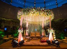 an outdoor stage decorated with flowers and lights for a wedding reception at the hilton hotel