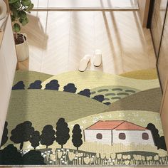 a door mat with a house and trees on it in the middle of a hallway