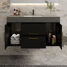 a bathroom vanity with marble counter top and black cabinet