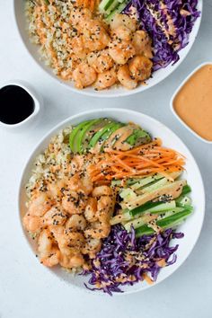 two white bowls filled with shrimp and veggies next to dipping sauce on the side