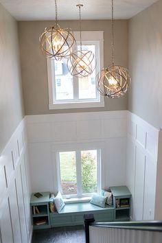 an overhead view of a room with some lights hanging from the ceiling and bookshelves