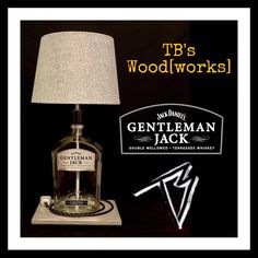 a lamp that is sitting on top of a table next to a sign with the name gentleman jack