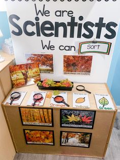 a table with posters and pictures on it in front of a sign that says we are scientist