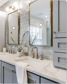 a bathroom with two sinks and mirrors in it