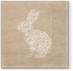 a napkin with a white rabbit on it and flowers in the shape of a bunny