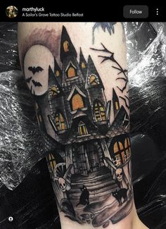 a tattoo with a castle and bats on it