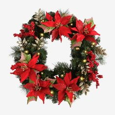 a christmas wreath with poinsettis and lights