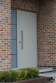 a large white door sitting next to a brick building