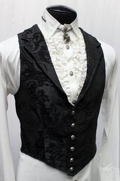 Note: These vests are very fitted. Check the size measurements below very carefully to find the size that will fit you best. A Victorian gentleman's vest with class. Great for formal occasions, can be worn under a suit jacket or by itself. Made in rich black on black tapestry fabric with black satin lining and back. This vest has a very flattering tapered fit and ties in back with satin belting so it can be made tighter in the waist. Fastens in front with six metal buttons. A notched collar adds Aristocrat Vest, Gothic Suit, Classy Gentleman, Black Tapestry, Country Gentleman, Style Gentleman, English Gentleman, Fancy Suit, Victorian Clothing