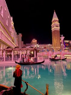 a gondola in the middle of a city at night